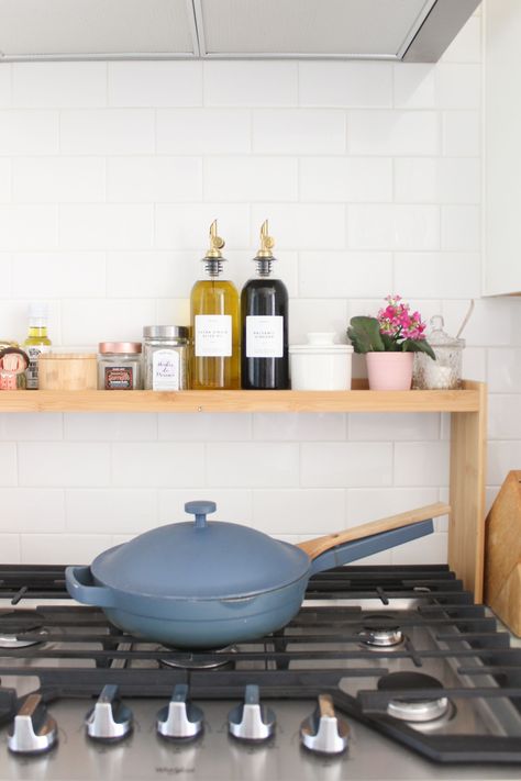 white kitchen - over stove shelf - bamboo shelf kitchen - shelf for over stove - small kitchen hacks - small kitchen storage - townhouse kitchen Above Oven Decor, Above Stove Shelf, Over Stove Shelf, Shelf Above Stove, Oven Decor, Over The Stove Shelf, Stove Shelf, Lamp In The Kitchen, Townhouse Kitchen