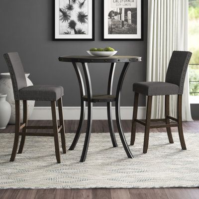 Be it everyday meals with the family or casually catching up with close friends over coffee, this five-piece dining set is the perfect pick for your abode. The included table features four legs, a circular tabletop, and decorative nailhead trim in the color bronze. The two matching chairs all showcase an espresso finish down below and are upholstered with cotton and linen awash in a near-neutral color. Color: Gray | Bistro Table - Greyleigh™ Haysi 2- Person Bar Height Dining Set Wood/Metal in Gr Set Meja Makan, Kursi Bar, Table Bistrot, 3 Piece Dining Set, Pub Table Sets, Bar Table Sets, Solid Wood Dining Set, Patio Bar Set, Dining Chair Design