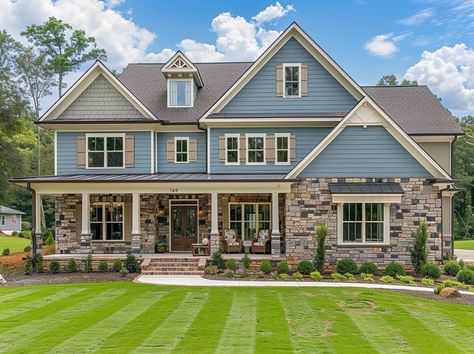 A beautiful light blue and gray house with stone accents, nestled in the lush greenery of North Carolina's suburban neighborhood., new construction home for sale , sunny day, traditional architecture style, a white front porch with an area decorated as if it was set up to be used at a luxury estate barbecue, white shutters on large windows, front yard is neatly trimmed grass with some flower beds and landscaping elements, the background shows other houses and trees in the distance, real photo Pretty Suburban House, Gray House With Stone, Medium House Exterior, Blue Suburban House, Cute Suburban House, Suburban House Exterior, Family Home Exterior, White Front Porch, Landscaping Elements