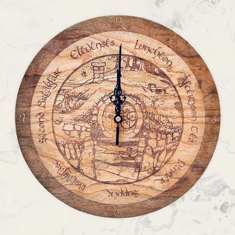 I make these nifty Cherry Wood Hobbit clocks here in Midway, Utah (The Shire, as I call it) from locally harvested and sustainable woods. (No, we didn't kill the ent wives) "Sure we've had one breakfast, but what about second breakfast, elvenses, luncheon, Afternon tea, Dinner, Supper? Does he know about them?" Now he can! Enjoy this 12" diameter hobbit clock that tells the most important times. Perfect for your kitchen, and your Lord of the Rings loving friends. Lord Of The Rings Kitchen, Tolkien Decor, Hobbit Kitchen, Shire Hobbit, Lord Of The Rings Decor, What About Second Breakfast, Flexible Wood, Hobbit Hole, Second Breakfast