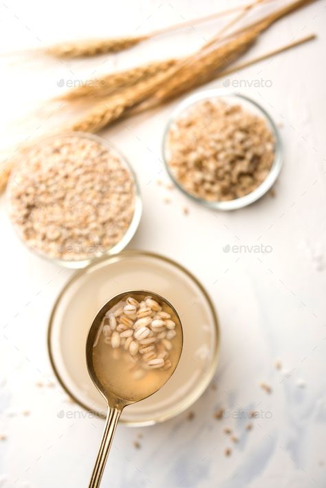 Barley Water by stockimagefactory. Barley water in glass with raw and cooked pearl barley wheat/seeds. selective focus #Sponsored #water, #glass, #raw, #Barley Water In Glass, Wheat Seeds, Barley Rice, Barley Water, Pearl Barley, Hijab Cartoon, Water Glass, Eating Raw, Aesthetic Images