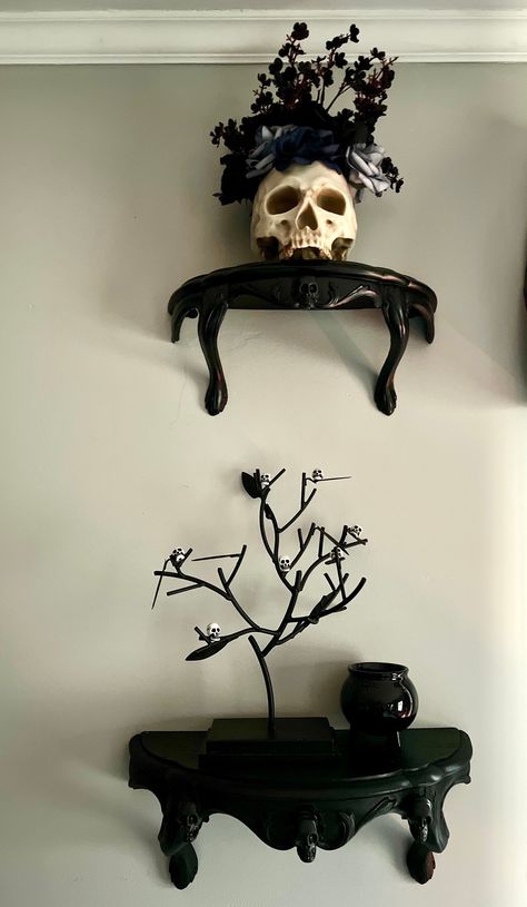 "Black ornate floating shelf, refurbished vintage item, 11.5\" display shelf, Victorian gothic display shelf, gothic home decor, black skull shelf  Made to order... processing time is approx 9 days Larger shelf and medium shelves available, sold separately. Made of hard composite resin material, lightweight and easy to hang, set of two hangers on the back of each shelf  Medium shelf is approx 11.5\" x 5.5\" x 5 \" Painted in satin black with one mini black skeletons on the front  Large shelf measures approx 14\" x 7\" x 6.5\" Painted satin black with three skeletons on the front (not currently in stock- these will be made to order on first come firs serve basis)  medium shelf set of two - with three mini skulls on front Please allow additional processing time.  Thank you Sold separately- G