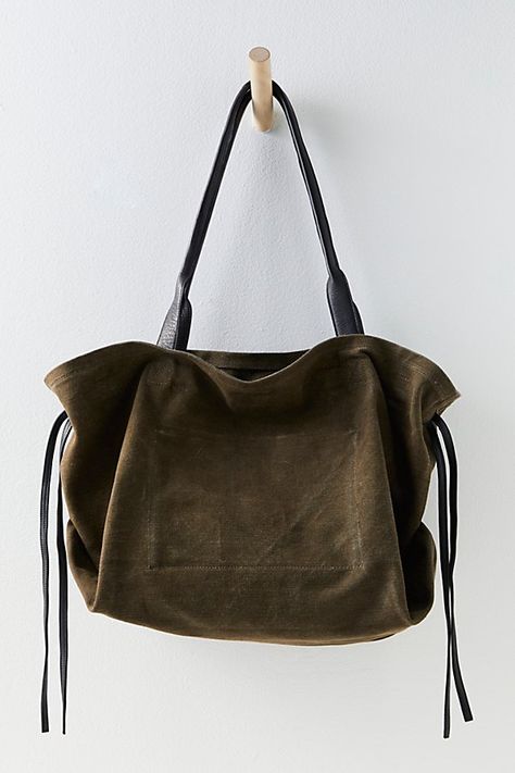 Easy and relaxed, this chic tote bag is featured in a slouchy style and canvas fabrication, with leather details for an edgy touch. **Features:** Tote style, slouchy design, canvas fabrication, leather tie sides, top handles, cinched closure, interior zip pocket **Why We | Daybreaker Tote by FP Collection at Free People in Rock Uni Bag, Slouchy Tote, Suede Tote Bag, Slouchy Style, Leather Tie, Suede Tote, Craft Tote Bag, Winter Girls, Winter Fashion Outfits