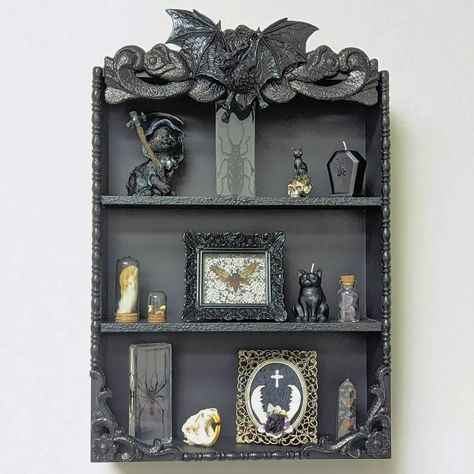 Out Of The Darkwell | Los Angeles, CA | New and now available! Vampire Bat Gothic Shelf. Beautifully detailed 3 tier shelf with a resin bat at the top. Great size for small curio… | Instagram Vampire Manor, Dark Academia Garden, Bat Shelf, Gothic Bookcase, Gothic House Decor, Gothic Shelf, Dark Room Decor, 3 Tier Shelf, Bat Decor