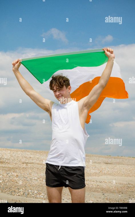 Young adult caucasian male holding on a beach holding the flag of the Republic of Ireland Stock Photo - Alamy Person Holding Flag Reference, Republic Of Ireland, The Flag, The Republic, Drawing Reference, Hold On, Resolution, Flag, Stock Photos