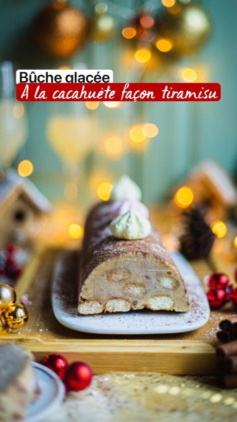 a piece of cake sitting on top of a wooden cutting board next to christmas decorations