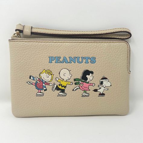 Fast Free Shipping  100% Authentic 30 Day Returns Coach X Peanuts Corner Zip Wristlet With Snoopy & Friends Motif Ivory CF213 • New with tags • MSRP $118 • Refined pebble leather • Two credit card slots • Zip-top closure, fabric lining • Wrist strap attached • 6 1/4" (L) x 4" (H) x 1/2" (W) • This special Coach x Peanuts collaboration combines Coach's legacy of leathercraft with the playful attitude of the Peanuts crew • Style No. CF215 • UPC: 195031742033 • Color: Gold/Ivory Multi About Me • 100% Authentic Merchandise Purchased Directly From The Manufacturer • 5 Star Positive Feedback Rating • FAST & FREE Shipping • Save me as a seller and check out my store for all my deals! This is 100% authentic, brand new with the tags still on. All of the items I sell are purchased directly from the Snoopy Friends, Coach Legacy, Snoopy Wallpaper, The Peanuts, Juicy Couture Bags, Peanuts Snoopy, Leather Wristlet, Stylish Bag, Zip Top