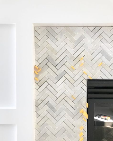 Carrara marble herringbone tile on a fireplace surround. Herringbone Fireplace Surround, Herringbone Tile Fireplace, Herringbone Fireplace, Fireplaces Layout, Craftsman Fireplace, Tall Fireplace, Life On Virginia Street, Wooden Fireplace, Paint Fireplace