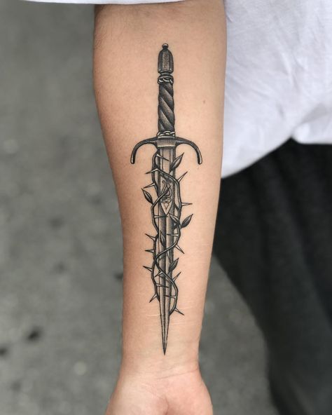 Dagger and thorns tattoo by Javier Betancourt inked on the right forearm Small Dagger Tattoo, Traditional Dagger Tattoo, Thorn Tattoo, Tato Tradisional, Knife Tattoo, Forearm Band Tattoos, Fire Tattoo, Dagger Tattoo, Arm Tattoos For Guys