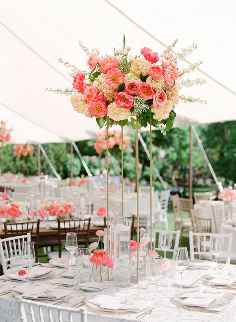 Coral peony, coral pink garden rose, peach hydrangea, white delphinium, lysimachia, peach ranunculus - tall gold stand, floating candles, small glass bud vases - tall round table centerpiece