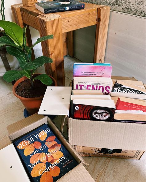 Books in moving boxes, surrounded with plants and tables House Moving Aesthetic, Moving Box Aesthetic, Moving In Asethic, Move In Day Aesthetic, Moving Out Boxes Aesthetic, Vision Board Moving Out, Move Out Aesthetic, Moving Out Of State Aesthetic, The Right Move Aesthetic