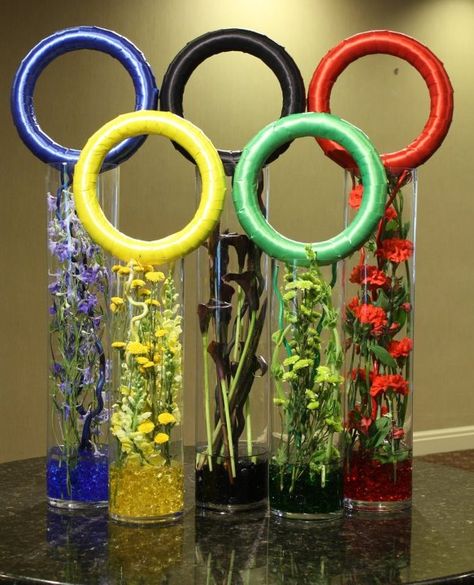 Olympic-inspired Flowers By Crossroads Florist in Mahwah NJ  "“Go Team USA” A great way to support the colorful Olympic rings are with coordinating vases of fresh flowers." Olympics Decorations, Olympic Theme Party, Olympic Crafts, Summer Camp Themes, Olympic Theme, Olympic Party, Facebook Photo, Olympic Rings, Table Centerpiece Decorations