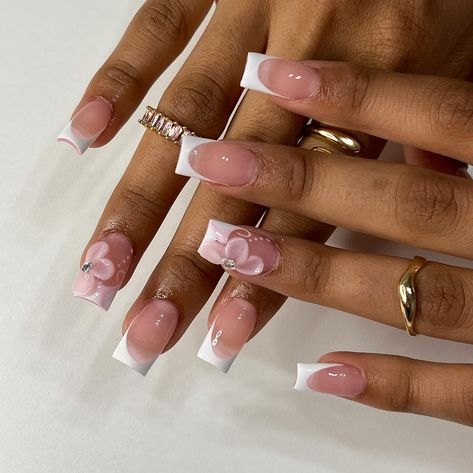 🌸 • • • • #nailsxkay #nailsnailsnails #apresnails #gelx #gelxnails #prettynails #trendynails #naildesign #nailart #nailextentions #bombnails #cutenails #baddienails #nailinspo #pinterestnails #trendynails #explore #explorepage #scvnails #calinails #LAnails #summernails #nailsofinstagram #LAnailtech #flowernails #frenchtipnails #3dflowernails Barbados Nail Design, Almond Pink Flower Nails, Nails One Finger Design, White Tip Acrylic Nails With Design, French Tip Acrylic Nails With Flower, Pink French Tip With Flowers, Short Acrylic Nails With Initials, Xs Nails, Acrylic Flowers On Nails