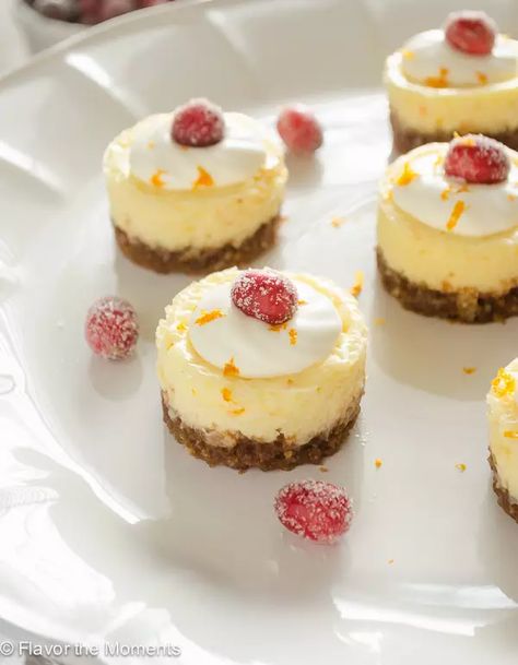 Mini Cranberry Orange Cheesecakes with Gingersnap Crust are an explosion of flavor!  They're topped with sugared cranberries for a festive holiday dessert! #cheesecake #cheesecakerecipes #dessertrecipes #glutenfreedessert