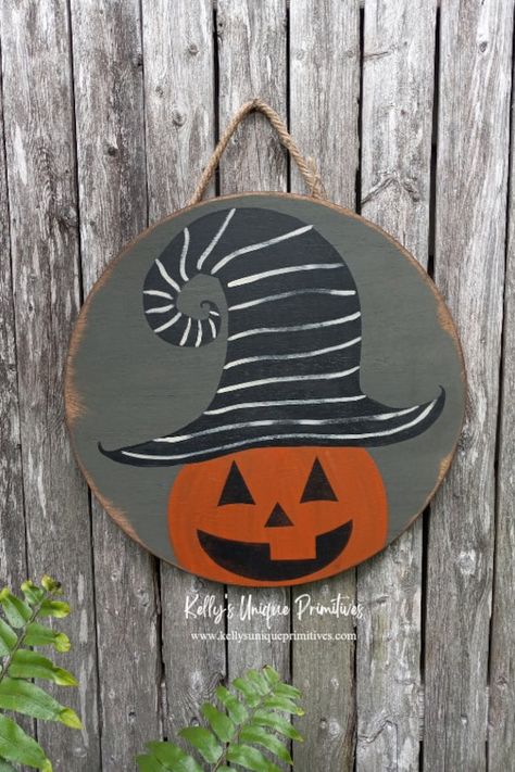 Primitive Jack-O-Lantern Door Hanger! Our primitive Jack-O-Lantern door hanger is hand cute, painted and given a beautiful distressed, primitive look. Comes with a rope hanger, so it's ready to be hung! The round measures approximately 15" diameter. ------------------------------------------------- ATTENTION: Due to the handmade nature of our products, our wooden items are considered primitive and unique. Some items that you will receive may have unique imperfections, such as small cracks, split Dollar Tree Wood Jack O Lantern, Dollar Tree Jack O Lantern Sign, Primitive Halloween Painting, Painted Wooden Jack O Lantern, Folk Art Jack O Lantern, Fall Wood Projects, 2023 Thanksgiving, Halloween Canvas Paintings, Woodshop Ideas