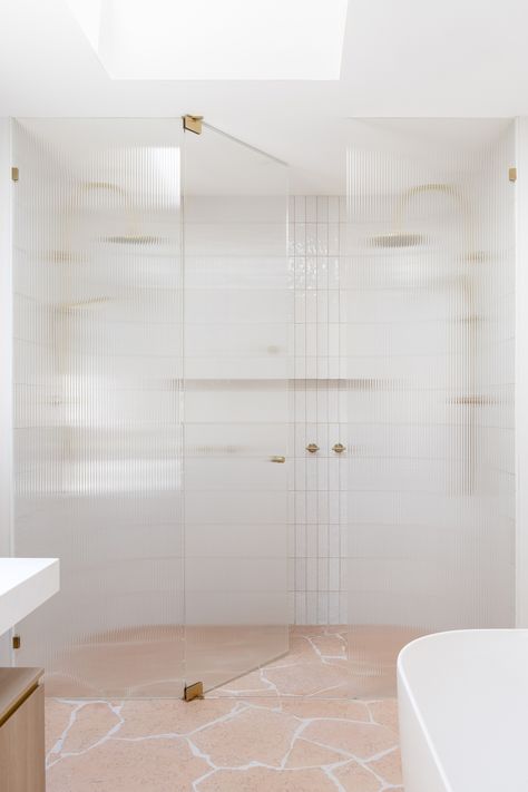 A brushed brass double shower is partially visible behind a fluted glass shower screen. A stunning crazy pave flooring tile ties the space together. Megan Gale, Abi Interiors, Melbourne Home, Master Ensuite, Mediterranean Style Homes, Bathroom Tapware, Concrete Basin, Kitchen Sink Taps, Soft Edges