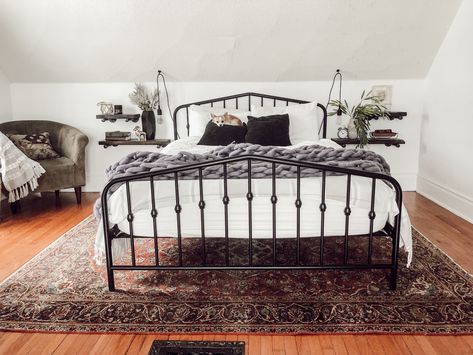 Funky Victorian Home Tour  White bedroom with black metal bed frame, vintage rug, floating shelf nightstands, and a sitting chair | Miranda Schroeder Blog Vintage Victorian House, Black Metal Bed Frame, Black Metal Bed, Black Bed Frame, Bedroom White, Wood Bed Frame, Bedroom Black, Trendy Bedroom, Metal Bed