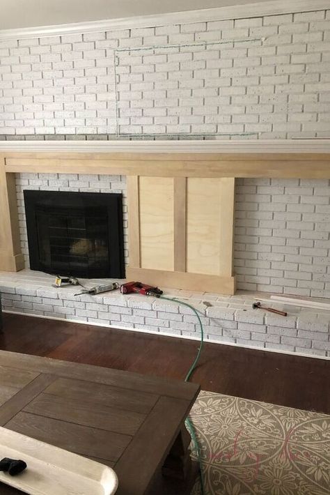 In this tutorial, you'll learn how to build a DIY fireplace mantel with built in bookcases. Step 1: Do a Mockup with TapeAs you can see in this image, we used masking tape to a mock up of where the mantel and built ins would go before we started the project!Step 2: Gather MaterialsFor this project, we used: (3) 4×8 sheets (1/2 inch) of Ecuadorian Plywood – (used for the majority of the project, for the mantel including the mantel posts and as backboard to connect the bookcases & man… Brick Fireplace With Brick Mantle, Extra Wide Fireplace Mantle, Built In Brick Fireplace, Whole Brick Wall Fireplace Makeover, Brick Wall With Fireplace Makeover, Off Center Fireplaces, Old Fireplace Remodel, Fireplace Wall Remodel, Off Center Mantle