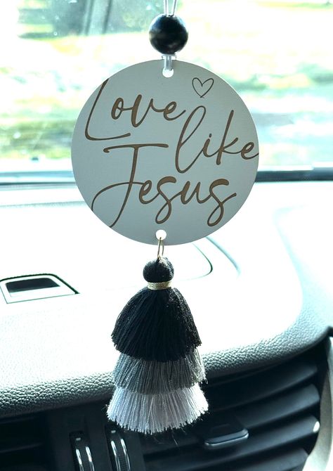 "Are you looking for the perfect way to accessorize your car while at the same time, add a little inspiration to your daily life?  Then, look no further than our new handcrafted car charms with inspirational messages!  Our laser cut and engraved car charms can be personalized with your favorite scripture or quote too! DETAILS: * SIZE: 3\" x 3\" wood circle... 1/8\" thick.   Tassel is approximately 3\" long. * ONE SIDED * COLOR:  white textured background (see pics -- white does have a glossy sheen to it). natural colored engrave  * Includes 1 bead and elastic hanging cord making it easy to hang * Back of car charm is solid white ** Please note: No two car charms will be identical since all wood varies, but we try our best to make them as close to the original listing photos as possible. ** White Textured Background, Car Mirror Hangers, Cricut Business, Suncatcher Diy, Car Charms Rear View Mirror, Mirror Decals, Mirror Car Accessories, Door Signs Diy, Ashley Nicole