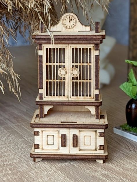 The Laser Cut Doll Furniture Cupboard is a versatile and charming addition to any dollhouse or miniature setting. This intricately designed cupboard features carefully crafted holes for easy fastening, making it ideal for use as an ornament or decor piece. Its detailed craftsmanship and functional design add a touch of realism to your miniature scenes. Whether you're a dollhouse enthusiast, a DIY decorator, or someone who appreciates finely crafted miniatures, this cupboard is a perfect choice f Wood Inspiration, Wood Projects For Kids, Miniature Scenes, Laser Cut Wood Crafts, Wood Games, Origami Paper Art, Laser Art, Wood Animal, Shapes For Kids