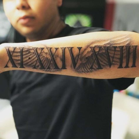 Roman Numerals For Men Over Arm Tattoos With Roman Numerals, Forearm Tattoos Roman Numerals, Roman Numbers Tattoo Arm, Mens Back Forearm Tattoo, Date Tattoos Men, Roman Numerals Arm Tattoo, Roman Numeral Tattoo With Design, Men Tattoo Ideas Roman Numerals, Writing Tattoos For Men Arm