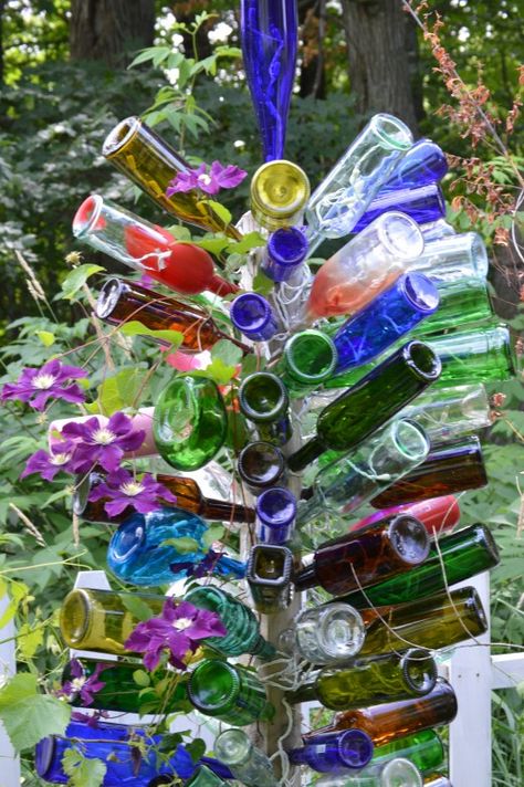 Clematis vine Glass Bottle Diy Projects, Wine Bottle Trees, Wine Tree, Old Wine Bottles, Bottle Trees, Diy Plastic Bottle, Empty Wine Bottles, Bottle Tree, Glass Bottle Diy