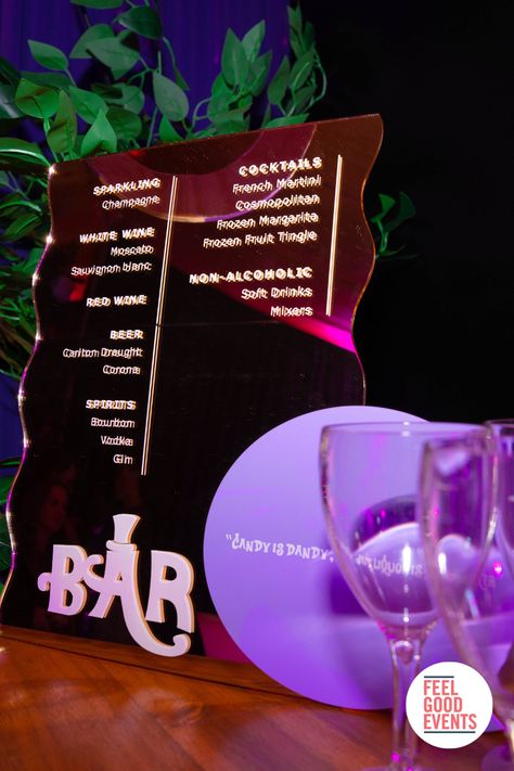 Gold acrylic bar menu in willy wonka theme Willy Wonka Movie Night, Willy Wonka Backdrop, Willy Wonka Dinner And A Movie, Wonka Themed Party, Wonka Chocolate Factory Themed Parties, Glasgow Willy Wonka Experience, World Of Pure Imagination, Wonderland Party Theme, Wonka Party