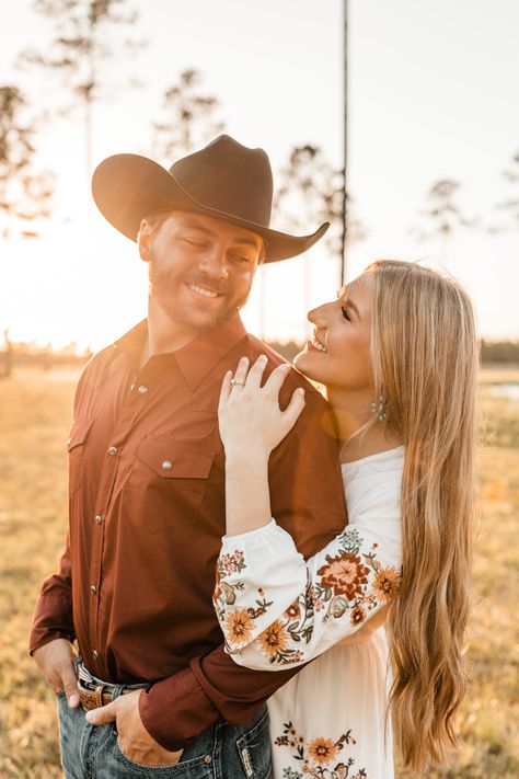 Western, boho, country, field, horse barn, horse farm, sunset, turquoise jewelry, white dress, embroidered dress, pearl snap, cowboy hat, boots, love, engagement photos, engagement ring, couples Fall Engagement Pictures Western, Engagement Photos Western Country Style, Western Couples Photos, Fall Western Engagement Pictures, Family Country Photoshoot, Hunting Engagement Pictures, Mexican Engagement Photos, Barn Engagement Pictures, Cowboy Engagement Pictures