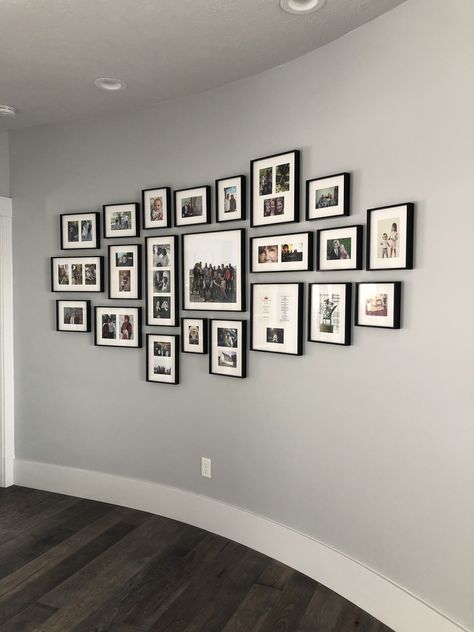 Family photos arranged on a curved wall create a cohesive grouping Curved Wall, Curved Walls, Texas Homes, Wall Gallery, Photo Frame Wall, Picture Wall, Picture Perfect, Family Photos, Photo Frame