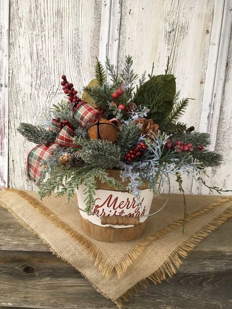 Santa Centerpiece, Holiday Centerpieces Christmas, Greenery Christmas, Wood Tote, Winter Arrangements, Winter Centerpieces, Christmas Bucket, Rustic Holiday Decor, Colonial Christmas