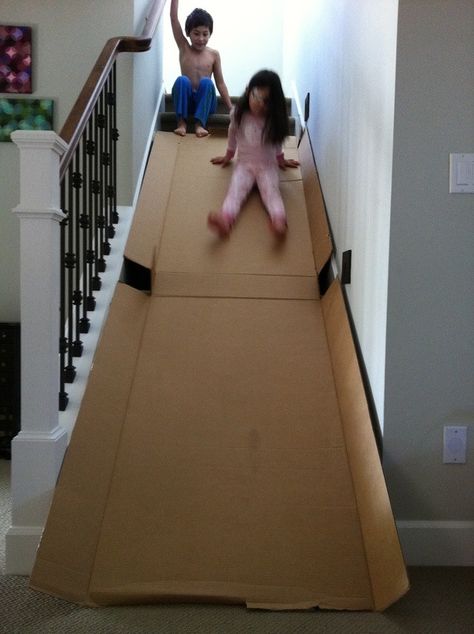 Fun thing to do with a refrigerator box and stairs!!! Love to do this myself Cardboard Box Fort, Cardboard Boxes Kids, Diy Karton, Stair Slide, Diy Slides, Carton Diy, Cardboard Box Crafts, Cardboard Toys, Diy Kids Toys