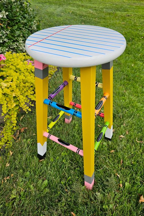 With pencils, crayons, and paper in mind, I transformed this ordinary stool into a craft supply masterpiece for my classroom! 🍎 Classroom Stools Painted, Diy Teacher Stool, Painted Classroom Chair, Teacher Chairs For Classroom Diy, Teacher Stools Painted Diy, Pencil Stool, Painted Teacher Stool, Teacher Stool, Teacher Stools