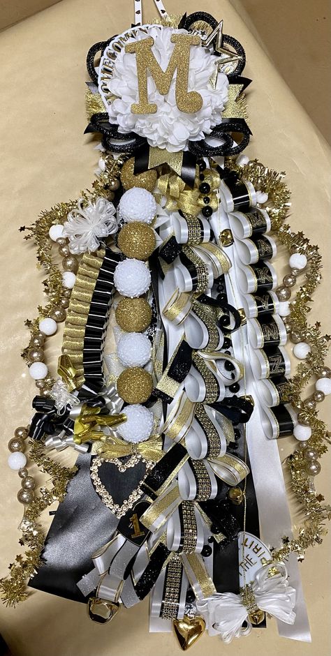 Homecoming Mums With Pictures, Western Theme Homecoming Mums, Homecoming Mum Instructions, Homecoming Ribbons Diy, Mum Chains Diy, Black Gold And White Homecoming Mums, Homecoming Braids For Mums Tutorials, Homecoming Sash Mums, Mum Chains