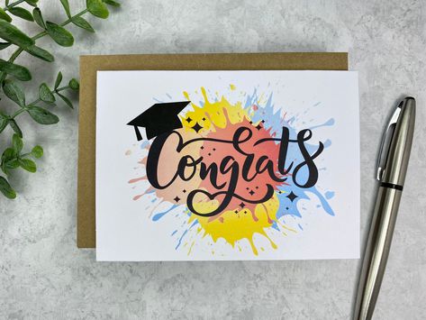 "Bright and Fun Graduation Card for the Class of 2021. Paint splatter with a Congrats and a cap. Perfect for the graduate whether it be Preschool, Kindergarten, 5th Grade, 8th Grade, High School, College, Nursing School, Law School, or School of hard knocks... celebrate that Graduate! - Blank inside, ready for your personal touch or a custom printed message (see below)* - 4\" X 5.5\", with brown kraft envelope. - designed, printed, packaged and shipped from my cozy studio in Nashville, TN - most Senior Class Of 2023, Watercolor Graduation, Graduation Cards Handmade, Calligraphy Cards, Paper Flower Art, Grad Cards, Trade School, Graduation Card, College University