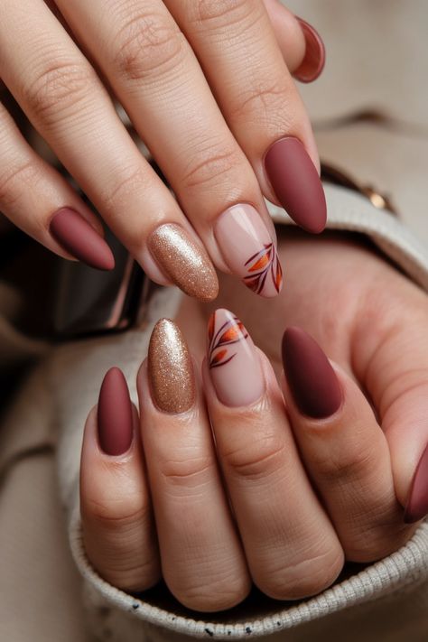 Dive into the beauty of the season with these stunning almond-shaped fall nail ideas! Imagine your nails adorned with rich burgundies, golden hues, and warm earth tones, perfectly capturing the essence of autumn. This chic nail style not only elongates your fingers but also allows intricate designs that reflect falling leaves and cozy vibes. Elevate your autumn look and let your nails do the talking! Fall Brown Almond Nails, Medium Almond Nails Fall, Oval Nails Autumn, Almond Thanksgiving Nails, Autumn Nails Leaves, Olive Green Almond Nails, October Almond Nails, Fall Almond Nails Designs, Almond Shaped Fall Nails