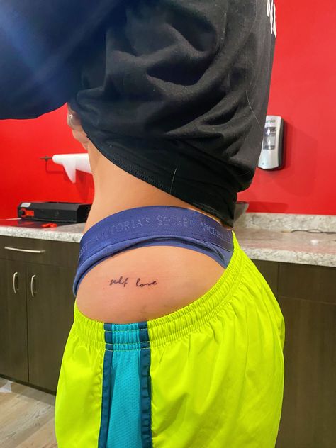 Small Word Hip Tattoos, Red Hip Tattoos Women, Self Love Hip Tattoo, Self Love Back Tattoo, Minimalist Tattoo Women Hip, Love Handle Tattoo, Eat Me Tattoo On Hip, Upper Hip Tattoo, Side Of Hip Tattoo