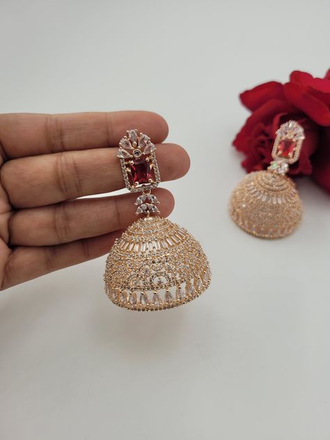 FLAT 20 % OFF ON EVERYTHING! HAPPY SHOPPING! SALE ENDS 31st MARCH! NainaTaraDesign will be closed from 31st Match to 1st May!Featuring a pair of big rose gold jhumki earrings with ruby red middle stone. Length- 6 cm approx., Width- 4.3 cm approx. Weight- .45 oz. approx. (each earring). --------------------------------------------------------------------------------------------------------------------------------------------------------------------------------------------------------------------- Jewellery Board, Jewelry Pakistani, Jhumki Earrings, Earrings Indian, South Indian Jewelry, Bollywood Jewelry, Pakistani Jewelry, Indian Earrings, Jewelry Indian