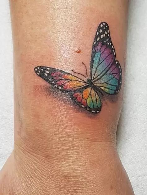 Butterfly Tattoo Meanings: Not Just A Beautiful Tattoo Rainbow Butterfly Tattoo Ideas, Small Rainbow Butterfly Tattoo, Butterfly Tattoo Blue And Purple, Butterfly Rainbow Tattoo, Butterfly Tattoo In Color, Colorful Butterfly Tattoo With Flowers, Butterfly Tattoo Colorful, Colourful Butterfly Tattoo, Butterfly Tattoo With Color