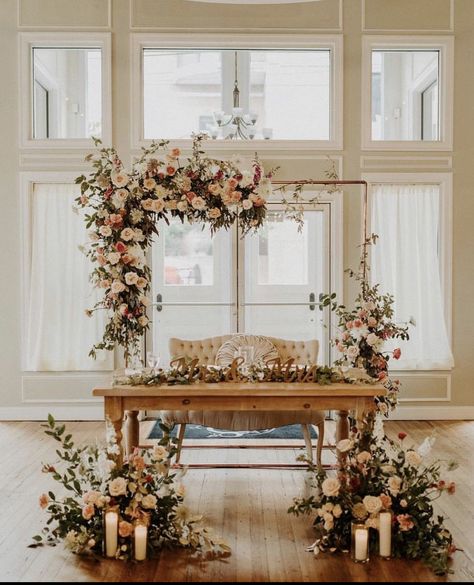 Beautiful fall colored flowers on the arbor behind the sweetheart table decorated with more flowers French Country Wedding Centerpieces, Sweetheart Table Florals, Bridal Table Backdrop, Country Wedding Centerpieces, Sweetheart Table Backdrop, Head Table Backdrop, Bride Groom Table, French Country Wedding, Jasmine Wedding