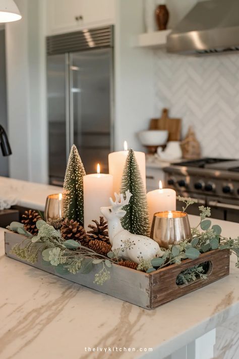 Festive kitchen centerpiece with lit candles, miniature trees, and a porcelain deer in a wooden tray. Christmas Counter Top Decorations, Above The Sink Christmas Decor, Christmas Wooden Tray Ideas, Christmas Kitchen Countertop Decor Ideas, Kitchen Bar Christmas Decor Ideas, Aesthetic Christmas Decor Kitchen, Christmas In Kitchen, Kitchen Winter Decorating Ideas, Christmas Round Tray Decor Ideas