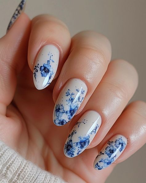 A photo of beautiful woman’s hand with white and blue porcelaininspired nail art, featuring intricate patterns inspired by classic Chinese ceramic designs. #floralnails #flowernails #summernails #springnails #thegelbottleinc #thegelbottle #biab #nailart #detailednailart Chinese Porcelain Nails, Blue White Nails Design, Blue China Nails, Porcelain Nail Art, Chinese Nails Designs, Blue Floral Nails, Porcelain Nails, Chinese Nails, Wedding Day Nails