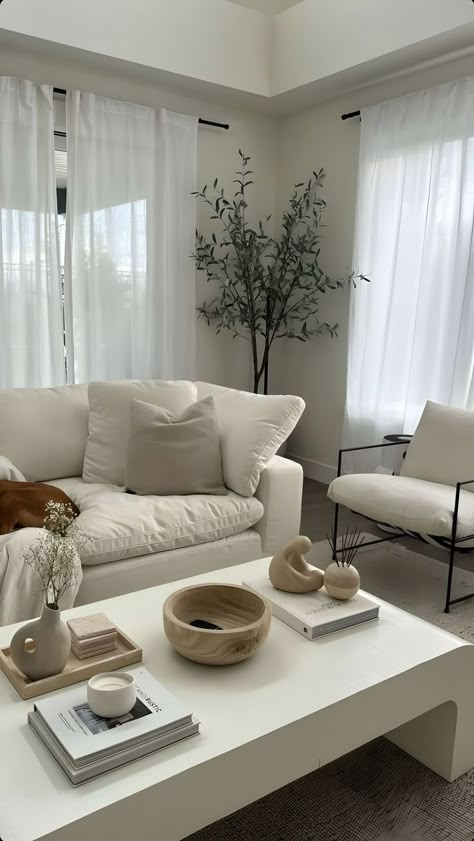 A picture of a beautiful living room decorated following a minimalistic approach. Main colors are different tones of beige and white and small pops of green. Minimalist Living Room Furniture, Minimalist Living Room Apartment, Minimalist Living Room Decor, Apartment Living Room Design, Dream Apartment Decor, Christian Motivation, Home Design Living Room, 1m Followers, Home Decor Shop