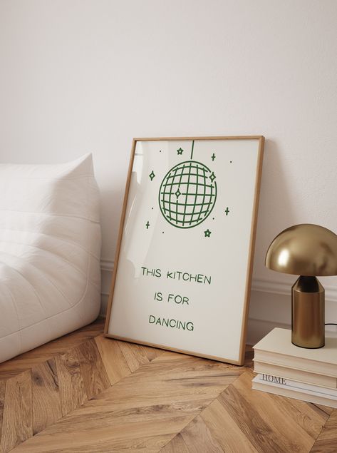 Add a playful touch to your kitchen decor with this trendy "Kitchen is for Dancing" poster. Featuring a whimsical disco ball illustration and the fun text "This kitchen is for dancing," this high-quality art print brings a lively and cheerful vibe to any cooking space. Perfect for those who love to dance while they cook, this poster serves as a joyful reminder to enjoy every moment in the kitchen. Its vibrant and engaging design makes it an excellent addition to your wall, creating an inviting and energetic atmosphere. This unique kitchen wall art also makes a fantastic gift for friends and family who share a love for food and dancing. Kitchen is for Dancing Poster, Trendy Kitchen Print, Cool Cute Cooking Kitchen Art Print, Kitchen Wall Poster, High Quality Print, Disco Ball Kitchen Poster This Kitchen Is For Dancing Poster, This Kitchen Is For Dancing, Green Disco Ball, Disco Ball Illustration, Cooking Poster, Fun Kitchen Decor, Ball Illustration, Kitchen Is For Dancing, Poster Food