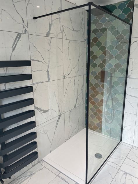 A marble tiled en-suite shower room featuring black shower, black framed glass shower screen, black tall towel rail and fish scale design tiles behind the shower. Mermaid Tile Bathroom, Porceline Tile, Mermaid Tile, Bathroom Black, Black Shower, Heated Towel Rail, Heated Towel, Marble Effect, Towel Rail