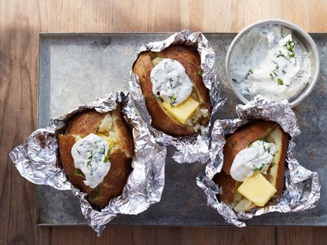 Camping Baked Potatoes with Herbed Sour Cream Recipe : Guy Fieri : Food Network - FoodNetwork.com Sour Cream Recipe, Shrimp Boil Foil, Camping Dinners, Vegetarian Bake, Sour Cream Recipes, Cereal Treats, Cast Iron Skillet Recipes, Campfire Food, Food Network Magazine