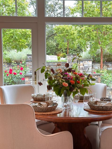 Round table set with florals looking out over beautiful gardens. Orangery Dining Room, Dining Room Round Table, Kitchen With Big Island, Round Table Set, Vaulted Ceiling Kitchen, Drop Zone, Big Kitchen, Table Table, Linear Lighting