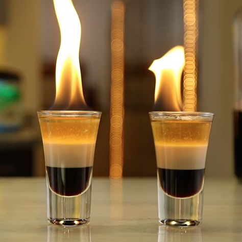 The Concorde is a flaming shot that will light up your night, trust us. This beautiful layered shooter mixes up coffee liqueur, Irish cream, and overproof rum for a little drink that you can literally light on fire. Seriously, if you want a shot you can light on fire, you need to try this drink out. Cocktail Shoot, Flaming Shots, Tipsy Bartender Recipes, Flaming Drinks, Shots Drinks, Shots Alcohol Recipes, Drink Image, Bacardi 151, Bartender Recipes