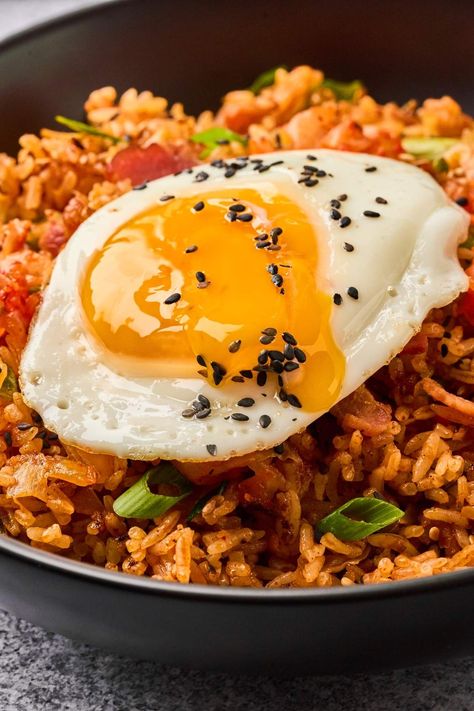 If you like experimenting with fried rice, you’ve got to check out this kimchi fried rice recipe. It’s loaded up with ingredients like kimchi, bacon, garlic, and Korean chili paste. Plus, it’s super-simple to whip up and you can have it ready in just 30 minutes. Got some leftover rice on hand? Perfect, this recipe is ideal for using up day-old rice and turning it into something amazing. Give it a shot and you'll be pleasantly surprised how you can make such a tasty dish with so few ingredients. Kimchi And Rice, Bacon Fried Rice Recipe, Kimchi Fried Rice Recipe, Hibachi Fried Rice, Korean Chili, Korean Chili Paste, Freezing Leftovers, Bacon Fries, Korean Rice