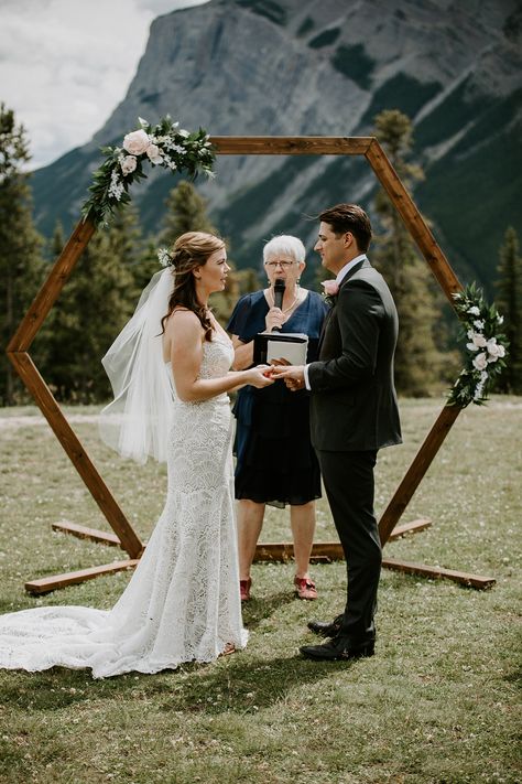 Fenlands Banff Wedding. Banff wedding. Mountain wedding. Tunnel mountain wedding in Banff. Hexagon arch wedding ceremony.   #Banffwedding #mountainwedding Black Triangle Wedding Arch, Arch Decoration Wedding Hexagon, Triangle Wedding Arch Greenery, Triangle Mountain Wedding Arch, Hexagon Wedding Arch Macrame, Hexagon Wedding, Wedding Ceremony Arch, Wedding Arch Flowers, Wedding Exits