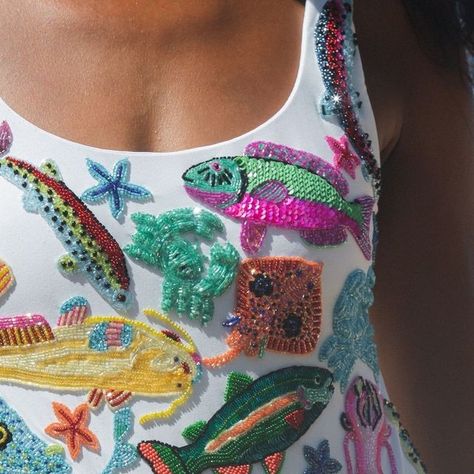 Oceanus on Instagram: "Swipe to see the story behind the new ARIZONA Swimsuit. Our Founder Hannah parked up by this Bali street food vendor and was mesmerised by the colours of the fish. ⁠ ⁠ This swimsuit is an art piece, embroidered with crystals by our highly skilled artisans.⁠ ⁠ Tap to shop this key piece of our SS24 collection.⁠ ⁠ #oceanus #fashion #swimwear⁠" Beads In Clothes, How To Embroider Beads, High Fashion Embroidery, Beading Clothes, Beaded Swimsuit, Beaded Swimwear, Fish Clothes, Embroidered Swimsuit, Artsy Boy